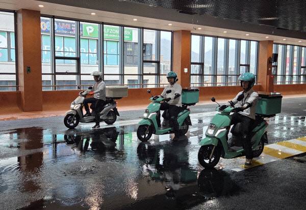 빗길 주행 훈련 시범을 보이고 있는 배민라이더스쿨 강사들. 물을 뿌린 노면 위에서 제동 타이밍과 균형 잡기를 선보이고 있다. (사진=한전진 기자)