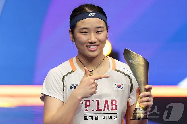 배드민턴 여자 단식 세계 최강 안세영이 21일 중국 선전 아레나에서 열린 2025 세계배드민턴연맹(BWF) 월드투어 슈퍼 750 중국 마스터스 여자 단식 결승에서 33분 만에 한웨를 2-0(21-11 21-3)으로 승리하며 우승을 차지했다. 우승을 차지한 안세영이 트로피를 들고 기념촬영을 하고 있다. 2025.9.21 ⓒ AFP=뉴스1 ⓒ News1 김성진 기자