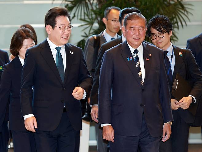 이재명 대통령과 이시바 시게루 일본 총리가 지난 23일 일본 도쿄 총리 관저에서 회담장으로 이동하고 있다. [연합]