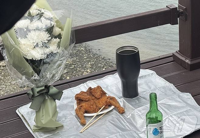 22일 인천 옹진군 영흥도 돌고래전망대 앞 숨진 해양경찰관 이재석 경사의 마지막 가는 길을 기리며 유족들이 마련한 추모식. 이 경사가 생전 좋아하는 커피와 치킨 등을 마련해놓았다.2025.9.22/뉴스1 ⓒ News1 박소영 기자