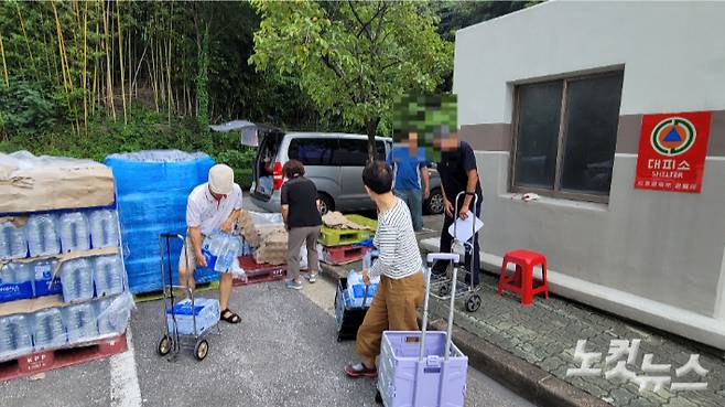 강릉의 한 아파트 주차장에서 생수를 배부받고 있는 주민들. 전영래 기자