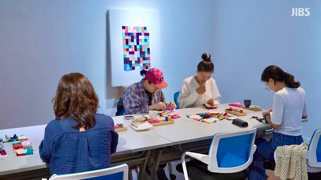 참여자들이 조각천을 꿰매며 아기 이불을 완성해가는 모습. 작은 바늘땀이 곧 마음의 연결이 된다.