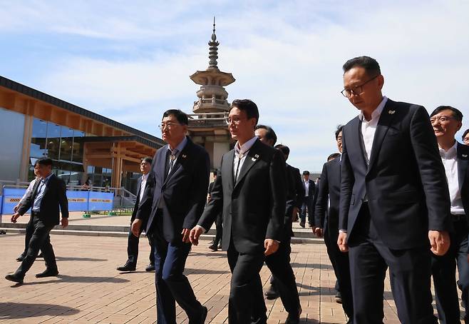 Prime Minister Kim Min-seok (front center) walks with officials through Gyeongju Expo Grand Park during an on-site inspection of 2025 APEC Summit preparations on Friday. (Yonhap)