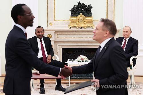 러시아·에티오피아 원전 건설 실행 계획 문서 교환 (모스크바 AP=연합뉴스) 25일(현지시간) 러시아 모스크바에서 알렉세이 리하체프 로사톰 사장과 게디온 티모테오스(왼쪽) 에티오피아 외무장관이 블라디미르 푸틴 대통령과 아비 아머드 총리 등 양국 정상이 지켜보는 가운데 에티오피아 동부에 원전 개발·건설을 위한 실행 계획 문서를 교환하고 있다. 2025.9.26