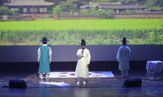 ▲ 23일 의성문화회관에서 열린 의성시낭송가협회 창립 20주년 특별공연 '詩의 노래, 의성의 노래'에서 오봉신지제 정위보 낭송가가 태극기를 배경으로 장중한 시 낭송을 펼치고 있다. 의성시낭송가협회