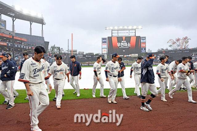 ▲ 우천 취소로 한화 선수들이 팬에게 인사를 하고 더그아웃으로 철수하고 있다.