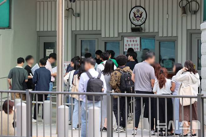 [서울=뉴시스] 권창회 기자 = 22일 서울 종로구 주한미국대사관 앞에서 시민들이 미국 비자심사를 받기 위해 줄 서 있다. 미국이 21일부터 전문직 비자인 H-1B 비자 수수료를 10만 달러로 인상한데 이어 오는 30일부터는 전자여행허가(ESTA) 수수료를 40달러로 기존 수수료보다 약 2배 인상한다. 2025.09.29. kch0523@newsis.com