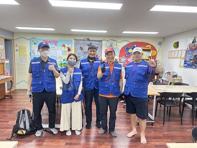 신중년 에어컨 청소전문가 사회공헌단의 3조인 김강표(왼쪽부터)씨, 성은경씨, 이규진씨, 권희택씨, 김두영씨가 지역아동센터에서 에어컨 청소 봉사를 끝내고 기념촬영을 하고 있다. 김두영씨 제공