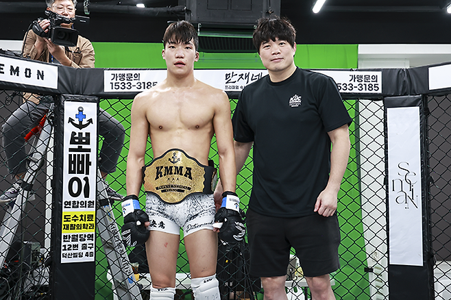 KMMA페더급 챔피언에 오른 김지경한테 KMMA 김대환 대표이사가 시상하고 있다. 사진=스탠다드앤드프로그레스 스포츠에이전시