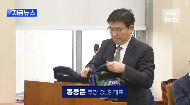 지난 1월 21일 국회 환경노동위원회 청문회에 출석한 홍용준 쿠팡로지스틱스 대표가 강득구 더불어민주당 의원의 요청을 받고 쿠팡 프레시백을 펼쳐보고 있다.