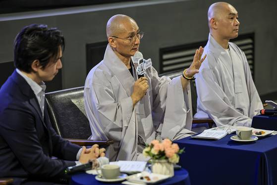 Buddhist monks Jin Gak, left, and Il Hwa answer questions from the audience [CULTURAL CORPS OF KOREAN BUDDHISM]
