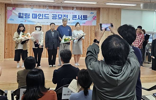 '조울병' 진단을 받은 뒤 10대 아이들과 떨어져 사회전환시설에서 지내는 유지연씨가 지난 17일 서울 은평구 서울시립은혜로운집에서 열린 ‘힐링 마인드 공모전, 콘서트’에서 수기 관련해 수상하고 기념 촬영을 하는 모습.