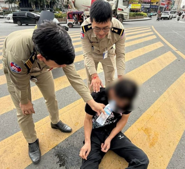 지난 21일(현지시간)  캄보디아 남서부 시아누크빌의 한 대로 로터리에서 도움을 요청하던 한국인 40대 남성이 현지 경찰에 발견된 모습.  [크메르타임스 홈페이지 캡처]