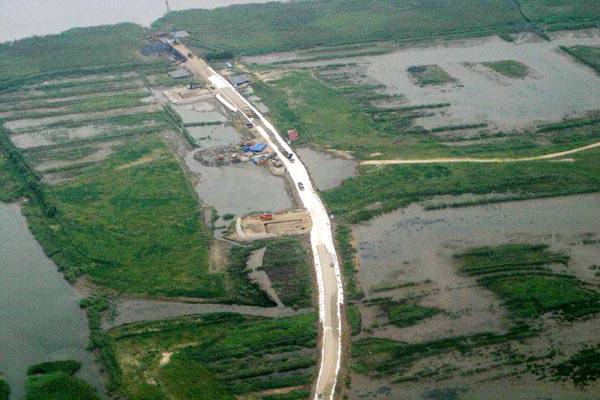 부산시는 을숙도대교 건설에 따른 생태계 피해를 최소화하기 위해 2000년 처음 ‘낙동강 하구 일원 환경관리계획’을 수립했다. 그리고 25년이 지난 지금, 환경관리계획을 새로 세우고 있다. 사진은 2005년 을숙도대교 착공 초기 철새 보호구역인 을숙도 습지가 시멘트(흰색)로 길게 덮여 훼손된 모습. 습지와새들의친구 제공