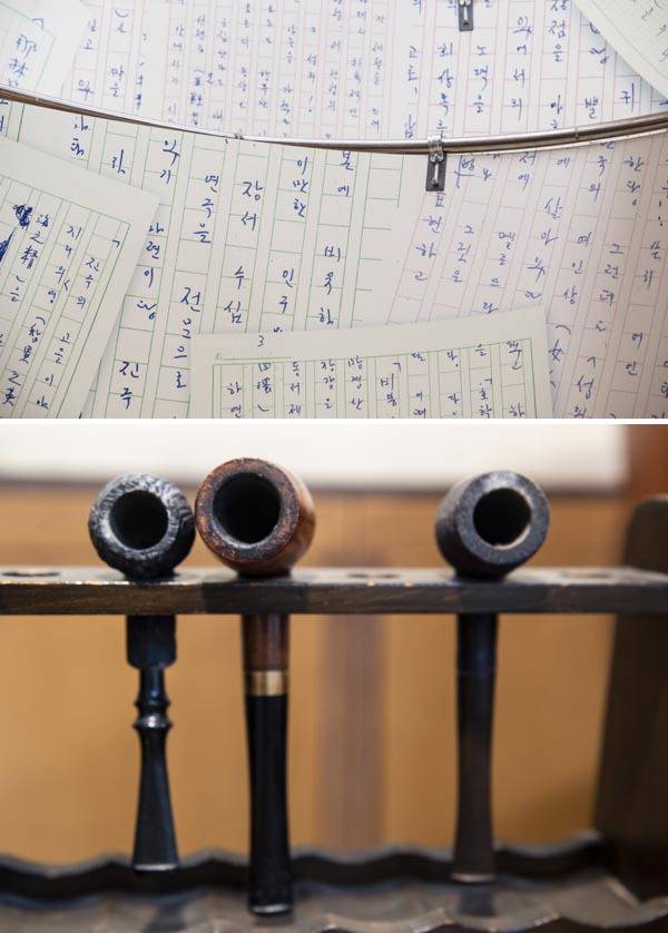 이병주문학관에 전시된 작가 이병주의 육필 원고(위쪽)와 그가 쓰던 담배 파이프.