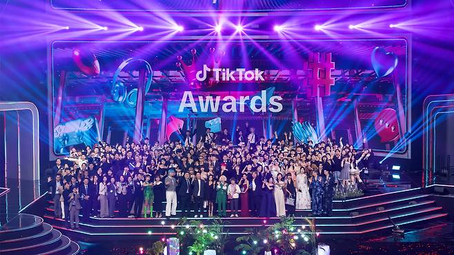 Participants of TikTok Awards 2025 pose for a photo on the stage at Korea University's Hwajeong Gymnasium in Seoul, Saturday. (TikTok Korea)
