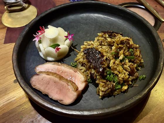 Biriyani and dry-aged duck slices are served with white pumpkin raita at Papa's in Mumbai [LEE JIAN]
