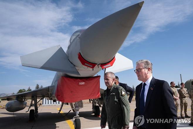 영국, 유로파이터 튀르키예에 공급키로 (AFP 앙카라=연합뉴스) 27일(현지시간) 오후 키어 스타머 영국 총리가 튀르키예 공군기지에서 영국군 유로파이터 타이푼 전투기를 지나며 걷고 있다. 2025.10.27 photo@yna.co.kr