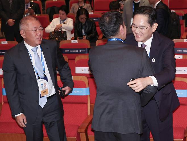 이재용 삼성전자 회장(오른쪽)과 정용진 신세계그룹 회장이 29일 경북 경주예술의전당에서 열린 ‘APEC CEO(최고경영자) 서밋’에서 포옹하며 인사하고 있다. 왼쪽은 정의선 현대차그룹 회장. 연합뉴스
