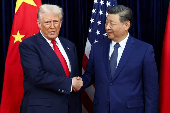 U.S. President Donald Trump, left, shakes hands with Chinese President Xi Jinping as they hold a bilateral meeting at Gimhae International Airport, on the sidelines of the Asia-Pacific Economic Cooperation (APEC) summit, in Busan on Oct. 30. [REUTERS/YONHAP]