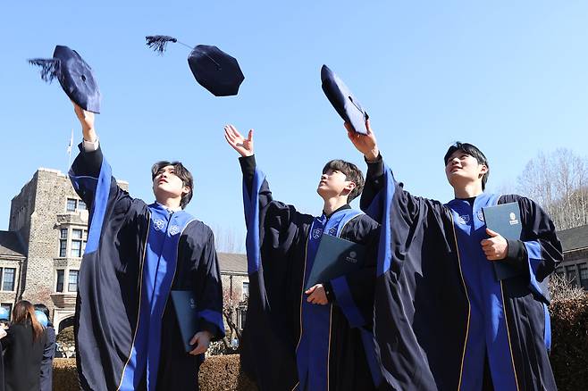 Yonsei University graduates throw their graduation caps in the air on Feb. 24, when the university's commencement ceremony was held. The university ranked 11th in the 2026 QS Asia Rankings. [YONHAP]