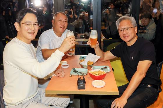 Nvidia CEO Jensen Huang, left, Samsung Electronics Executive Chairman Lee Jae-yong, right, and Hyundai Motor Group Executive Chair Euisun Chung hold up glasses at a meeting at a Kkanbu Chicken store in Gangnam District, southern Seoul, on Oct. 30. [NEWS1]