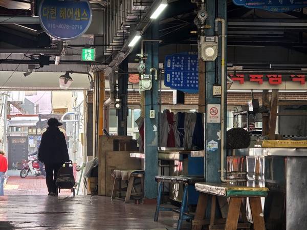 구암현대시장(창원시 마산회원구 구암동) 무허가 상가들이 영업을 중단했다. 한 시민이 6일 오전 운영을 멈춘 상가 주위를 지나고 있다. /최석환 기자