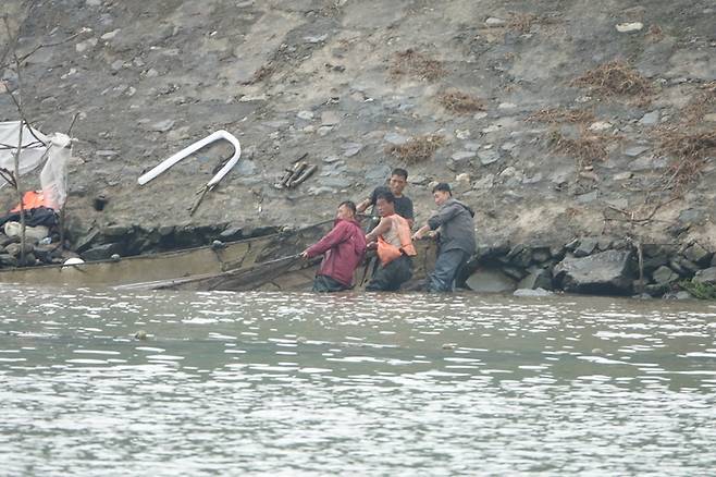 압록강에서 그물을 당기는 북한 어민들. <박진관기자>