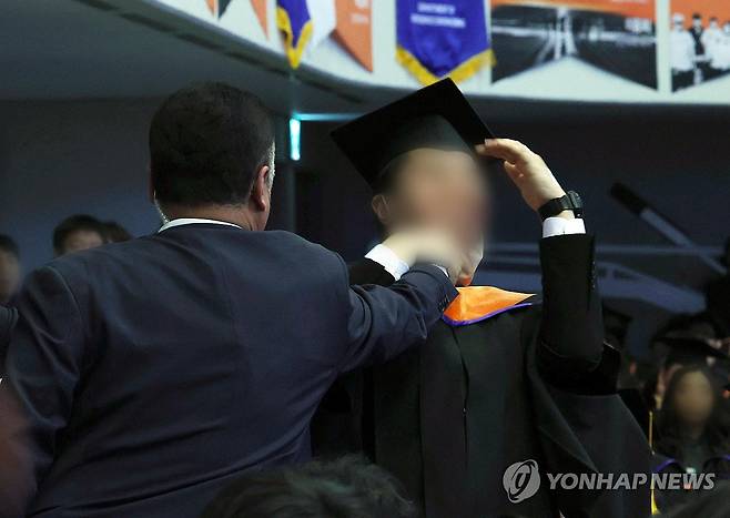 대통령 축사 도중 항의하다 제지 당하는 졸업생 (대전=연합뉴스) 홍해인 기자 = 2024년 2월 16일 대전 유성구 한국과학기술원(KAIST)에서 열린 2024년 학위수여식에서 한 졸업생이 윤석열 대통령이 축사를 할 때  R&D 예산과 관련해 자리에서 일어나 대통령을 향해 항의를 하던 중 제지를 당하고 있다. 2024.2.16 [대통령실통신사진기자단] hihong@yna.co.kr