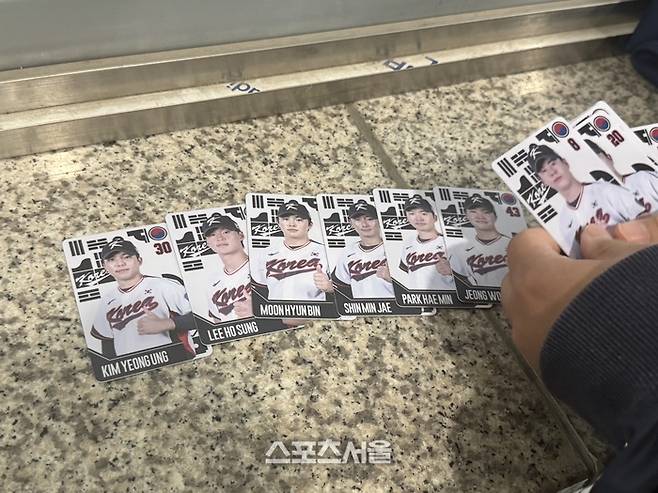 한 팬이 스포츠서울에 포토 카드를 보여주고 있다. 김영웅부터 문현빈까지. 여러 선수 카드가 무작위로 있었다. 고척 | 박연준 기자 duswns0628@sportsseoul.com
