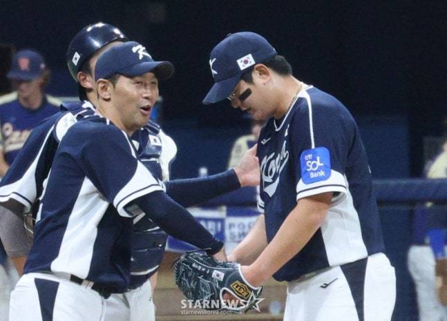 김서현(오른쪽)이 투구를 마치고 더그아웃으로 돌아오고 있다. 옆에는 격려해주는 최원호 코치. /사진=김진경 대기자