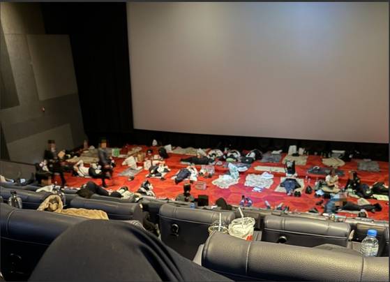 Police offers deployed to the 2025 Asia-Pacific Economic Cooperation (APEC) summit in Gyeongju, North Gyeongsang, sleep in a movie theater in this undated photo released by the Korean National Police Workers Council. [KOREAN NATIONAL POLICE WORKERS COUNCIL]