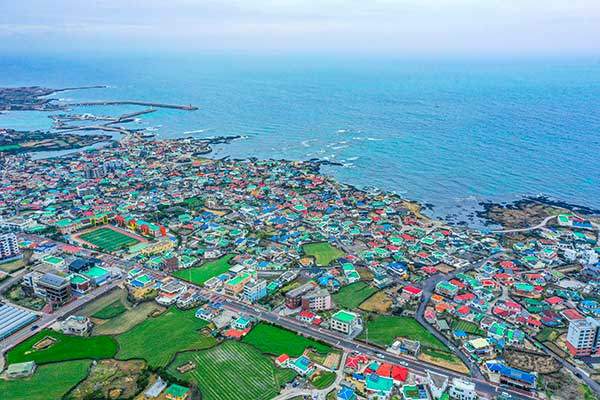 정상에서 본 김녕항과 김녕리. 대부분 이곳에 묻힌 이들의 후손일 것이다.