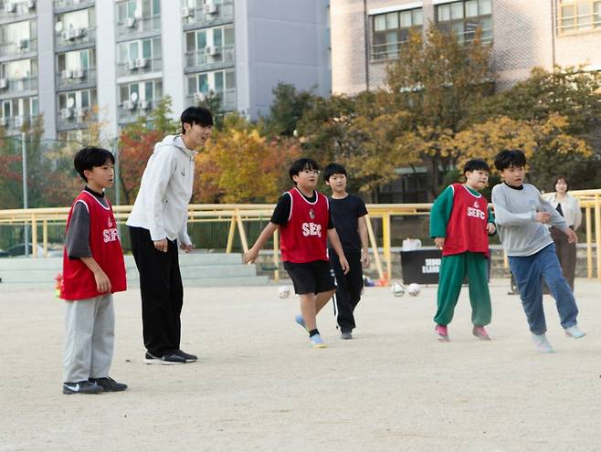 등원초등학교 학생들에게 축구를 지도하고 있는 서울이랜드 수비수 김하준(왼쪽 두 번째). /사진=서울이랜드 제공