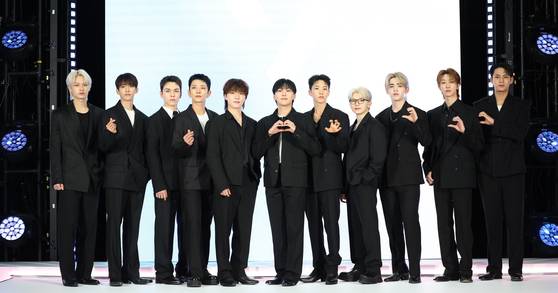 Seventeen members pose for photos at an Airbnb event at the Hanwha General Insurance's Hannam office in central Seoul on June 4. [NEWS1]