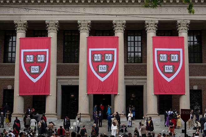 Harvard banners in front of Widener Library during the 374th Harvard Commencement in Harvard Yard in Cambridge, Massachusetts, on May 29. U.S. President Donald Trump is furious at Harvard for rejecting his administration's push for oversight on admissions and hiring, amid the president's claims the school is a hotbed of anti-Semitism and ″woke″ liberal ideology. [AFP/YONHAP]