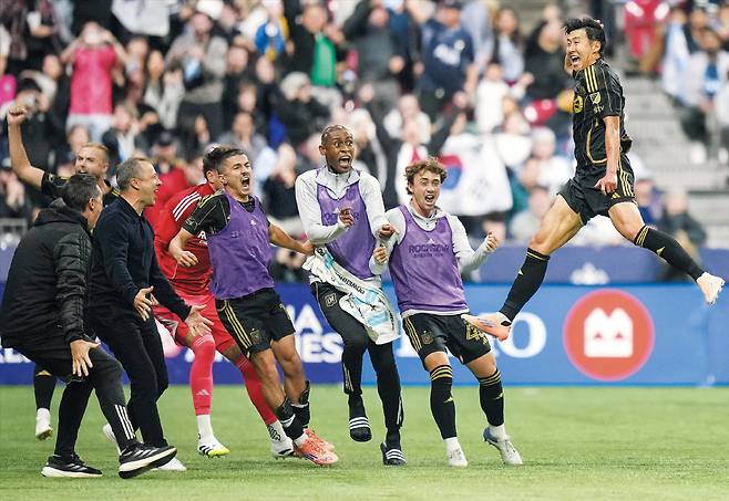 패색이 짙던 후반 추가 시간에 마법 같은 골이 터졌다. 23일 캐나다 밴쿠버에서 열린 LA FC와 밴쿠버 화이트캡스의 MLS(메이저리그 사커) 플레이오프 서부 콘퍼런스 준결승전. 손흥민(맨 오른쪽)이 후반 종료 직전 2-2 동점을 만드는 프리킥 골을 넣은 뒤 팀 동료들을 향해 뛰어가 하늘 높이 점프하며 기뻐하고 있다./AP 연합뉴스