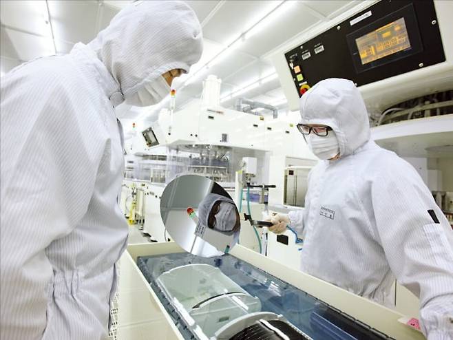 SK실트론 직원들이 웨이퍼 제품을 살피고 있다. / 사진=한경 DB