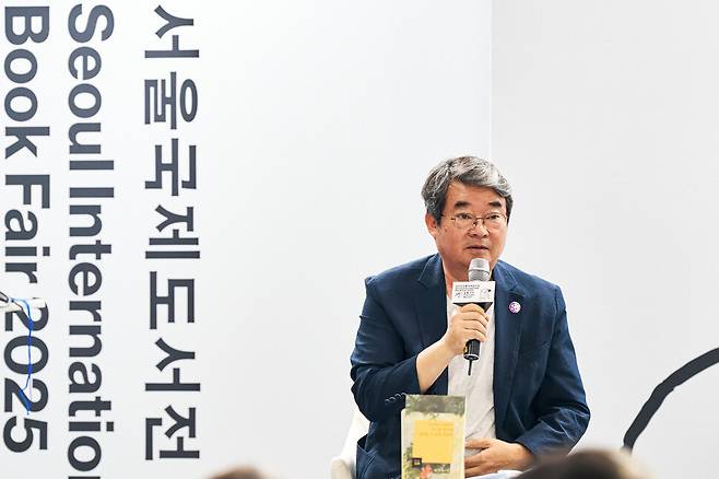 안도현 시인이 지난 6월 열린 서울국제도서전에 참가해 발언하고 있다. 시인의 앞에 놓인 책은 2020년 9월에 나온 시집 ‘능소화가 피면서 악기를 창가에 걸어둘 수 있게 되었다’다. 안도현 제공