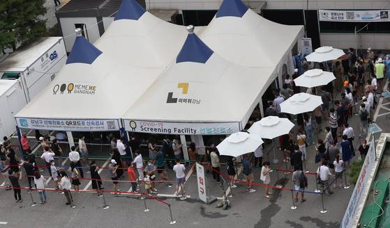 2021년 7월 코로나19 4차 대유행이 본격화하자 선별 검사 대기 줄이 다시 길어졌다. 서울 강남구 보건소에서 시민들이 검사를 받기 위해 대기 중이다. [연합뉴스]