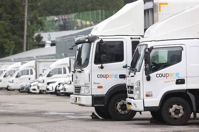 Coupang delivery vehicles are seen parked at a logistics center in Seoul on Aug. 6. [YONHAP]