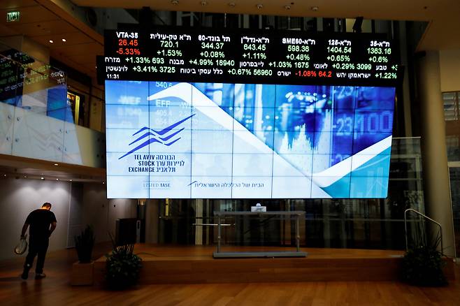 2020년 11월 이스라엘 텔아비브 증권거래소 앞 전자 게시판을 한 남자가 지나가고 있다. /연합뉴스