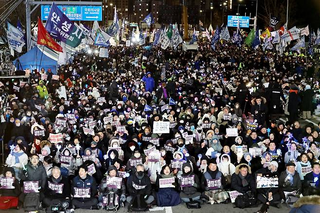Demonstrators gather in front of the National Assembly on Wednesday to mark the one-year anniversary of former President Yoon Suk Yeol's martial law decree and impeachment. (Yonhap)