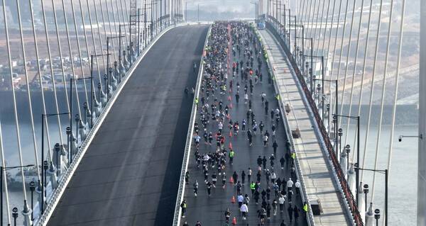 포근한 날씨를 보인 7일 인천시 서구와 중구 영종도를 연결하는 제3연륙교 개통기념 'WALK&RUN'행사에 참가한 시민들이 교량 위를 달리고 있다. 이진우 기자 ljw@kihoilbo.co.kr