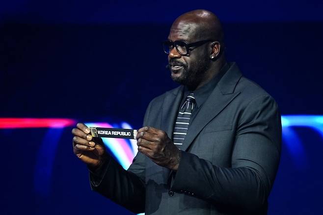 NBA 리빙레전드 샤킬 오닐이 지난 6일(한국시간) 미국 워싱턴DC에 있는 케네디센터에서 끝난 2026 북중미 월드컵 본선 조 추첨식에서 포트2 대한민국을 집어들며 펼쳐보이고 있다. 사진 | 워싱턴=AFP연합뉴스