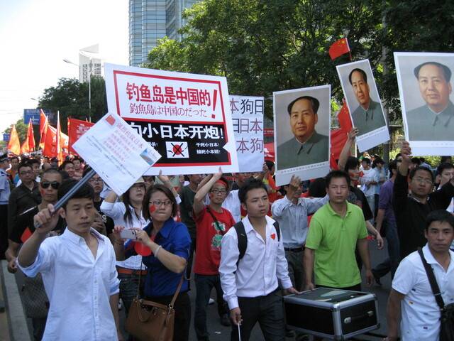 2012년 9월18일 중국 베이징 일본대사관 앞에서 벌어진 대규모 반일시위 참가자들이 마오쩌둥의 초상화와 반일 구호가 적힌 팻말을 들고 있다. 베이징/박민희 선임기자