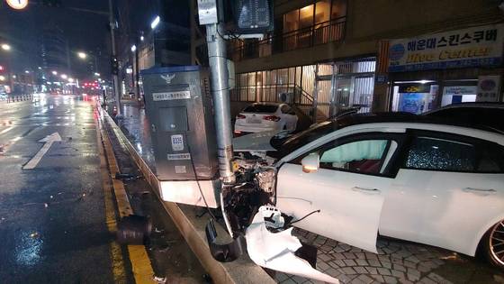 A car operated by a drunk driver is seen crashed into an electric pole near Haeundae Beach in Busan in July 2021. [BUSAN METROPOLITAN POLICE AGENCY]