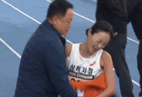 ◇2025 인천국제마라톤 국내 여자부 우승자 이수민(삼척시청)이 결승선을 통과한 뒤 자신을 막아세운 김완기 감독을 뿌리치는 모습. 사진=유튜브 캡처