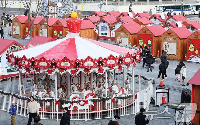 성탄절을 열흘 여 앞둔 14일 오후 서울 종로구 광화문광장을 찾은 시민들이 겨울동화 속 산타마을 콘셉트로 꾸며진 크리스마스 광화문 마켓을 둘러보고 있다. 산타마을 놀이광장과 마켓 빌리지 등 다양한 크리스마스 테마 공간으로 구성된 광화문 마켓은 오는 31일까지 진행된다. 2025.12.14/뉴스1 ⓒ News1 오대일 기자