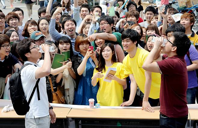 Students compete in a milk-chugging contest held as part of Konkuk University’s annual spring festival at the university's campus in Gwangjin District, eastern Seoul, on May 16, 2012. The festival also features an exhibition on dairy and meat products. [NEWS1]